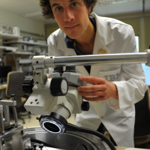 IBM scientist Colin Rawlings makes adjustments to nanopatterning tool.