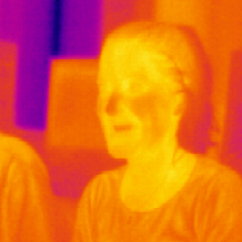 An image of two people in mid-infrared (\thermal\) light (false-color)