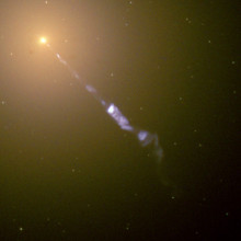  Streaming out from the center of the galaxy M87 like a cosmic searchlight is one of nature's most amazing phenomena, a black-hole-powered jet of electrons and other sub-atomic particles traveling at nearly the speed of light. In this Hubble telescope...