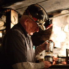 Tour guide at the Beckley WV Exhibition Coal Mine, showing the kind of safety lamp that replaced canaries as methane detectors.