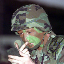 PFC Joel Graham puts on camouflage paint