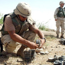  U.S. Army Sgt. Kirk Medina, from 759th Explosive Ordinance Disposal, out of Fort Erwin, Calif., attached to the 3rd Infantry Division (Mechanized), removes fuse from a Russian-made mine, while working together with soldiers from A Company, 10...