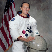Portrait of Astronaut Charles M. Duke Jr., in space suit with a lunar globe in front of him and an American flag behind him. NASA Photo ID: S71-51289 Source: http://spaceflight.nasa.gov/gallery/images/apollo/apollo16/html/s71-51289.html