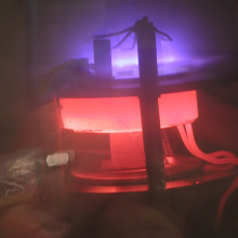 DC-PECVD system in action. DC plasma (violet) improves the growth conditions for carbon nanotubes in this chemical vapor deposition chamber. A heating element (red) provides the necessary substrate temperature.