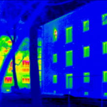 Thermal imaging of a Passive House, with a conventional building in the background