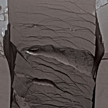 Secondary electron micrographs taken after a bending test on an unnotched Pd79Ag3.5P6Si9.5Ge2 glassy specimen. The sample did not fracture catastrophically after undergoing the entire bending strain applicable by the fixture.