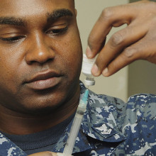 Healthcare worker drawing up influenza (flu) vaccine shot