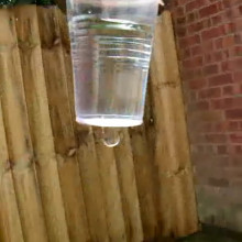 The cup dropping, showing how the flow of water stops.