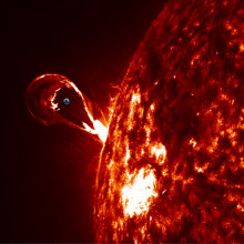 View of typical solar eruption using data from the NASA Solar Dynamic Observatory space mission. The Earth has been shown to show the gigantic size of the phenomena.