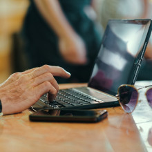 Person using a laptop at a table