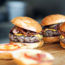 A few burgers on a table