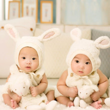 Twin babies in bunny outfits.