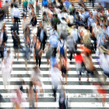 A crowd of people blurred from motion.