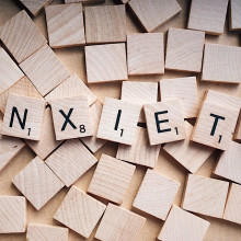 The word 'anxiety' spelled out in scrabble tiles.