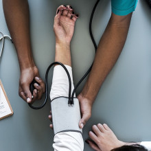 A patient's blood pressure being tested by a doctor.