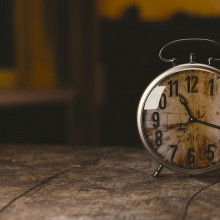 an old style alarm clock, faded with time