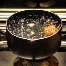 A pot of boiling water on a stove