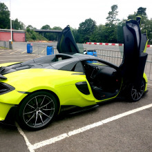 McLaren 600LT Spider parked on a racetrack with the doors open