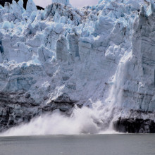 Ice breaking off a large ice shelf.