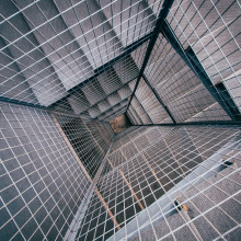 Aerial view of square spiral staircase with metal mesh