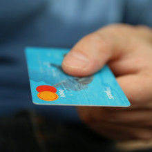 Person holding a blue bank card