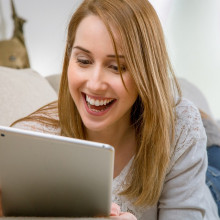 this is a picture of a woman using a tablet computer