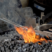 Sword sitting in a forge's embers 