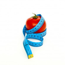 measuring tape around a tomato
