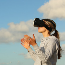 A woman gaming outdoors with a VR headset