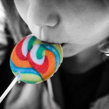 Girl eating a brightly coloured lollipop Girl eating a brightly coloured lollipop