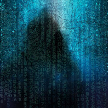 Lines of matrix-style green characters obscuring a hooded figure.