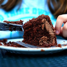 this is a picture of someone eating chocolate cake