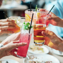 Group of alcoholic drinks held up by group