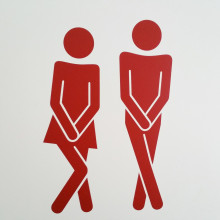 male and female stick people needing the toilet