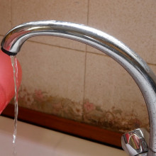 balloon next to a running tap