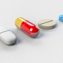 A line of differently-shaped pills.
