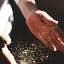 Dust blowing from a pair of hands