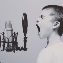 Child shouting into microphone