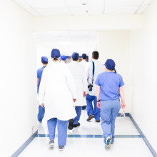 A team of doctors walking through a hospital corridor