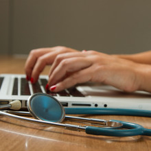 doctor on computer with stethoscope