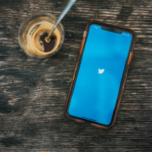 Phone displaying twitter in coffee shop