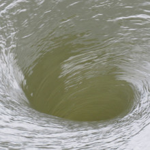 Water swirling into a vortex.