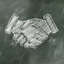 A handshake drawn on a chalkboard.