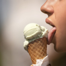 A person licking an ice cream cone