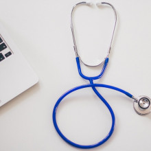 image of a stethoscope and a laptop computer