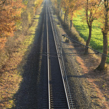 image of a train track with trees either side