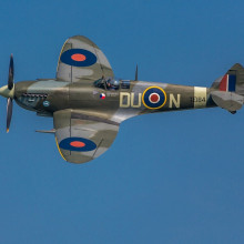 A spitfire aeroplane, flying through the air