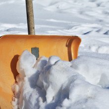 A snow shovel half-buried in snow.