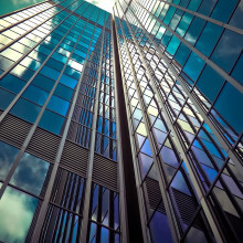 a view of a glass skyscraper shot from ground level