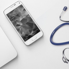 a laptop, smartphone and stethoscope